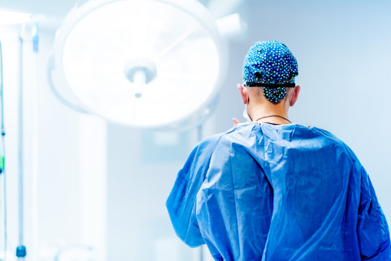 Artistic portrait of surgeon getting ready for surgery. Surgery scrubs, operating room and hospital details