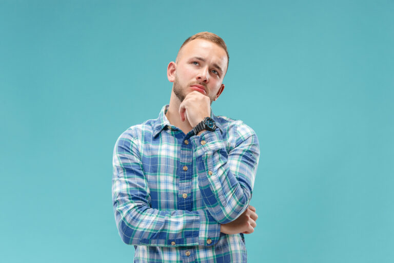 Young serious thoughtful businessman. Doubt concept.