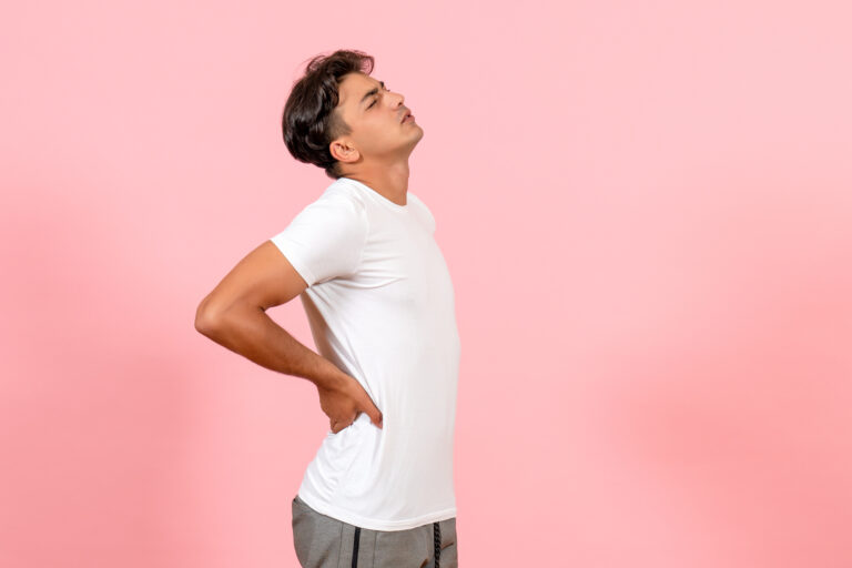 front-view-young-male-having-backache-on-pink-background-color-model-emotion-male